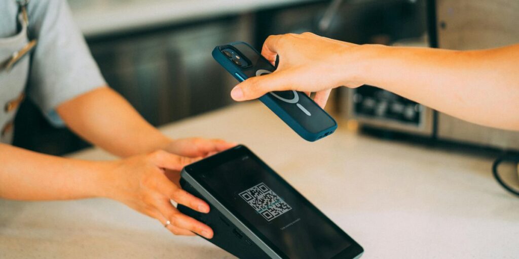 JazzCash Raast QR Merchants Hit 1.9 Million as Cashless Pakistan Push Accelerates 4 Customer scanning a QR code displayed on a payment terminal