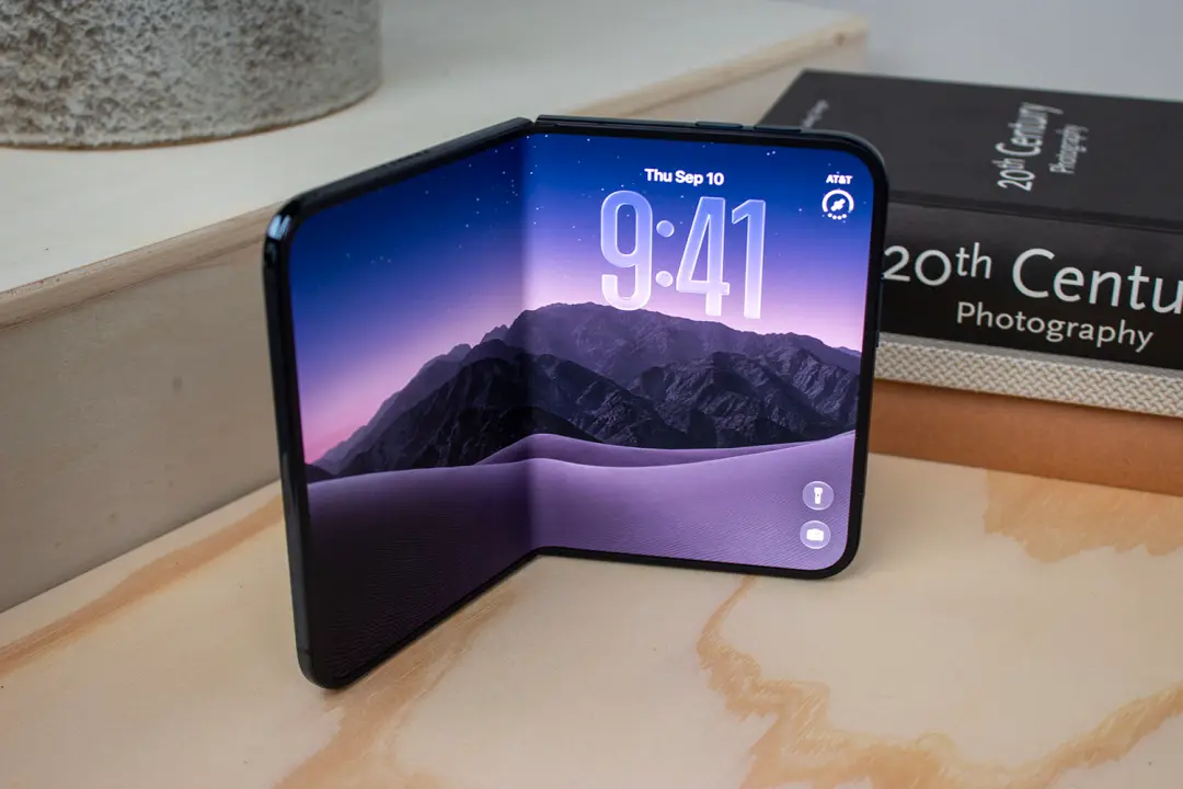 The iPhone Duo standing half-opened on a desk showing the folding inner display