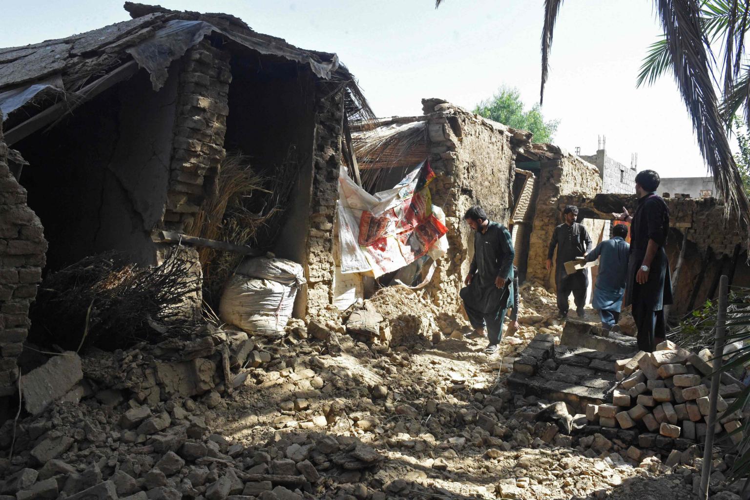Damaged mud-brick homes reduced to rubble after the 2021 Harnai earthquake in Balochistan