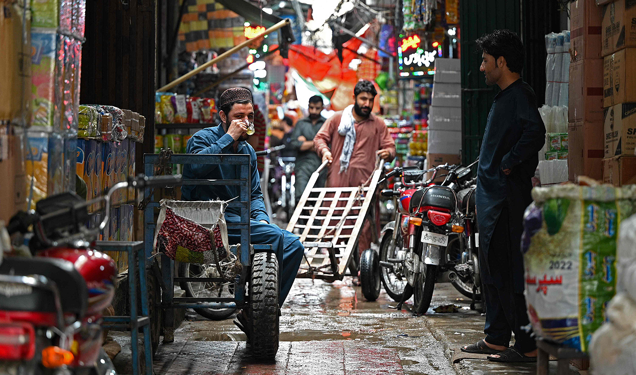 Workers and vendors in a busy Pakistani bazaar — the informal economy where millions earn their living