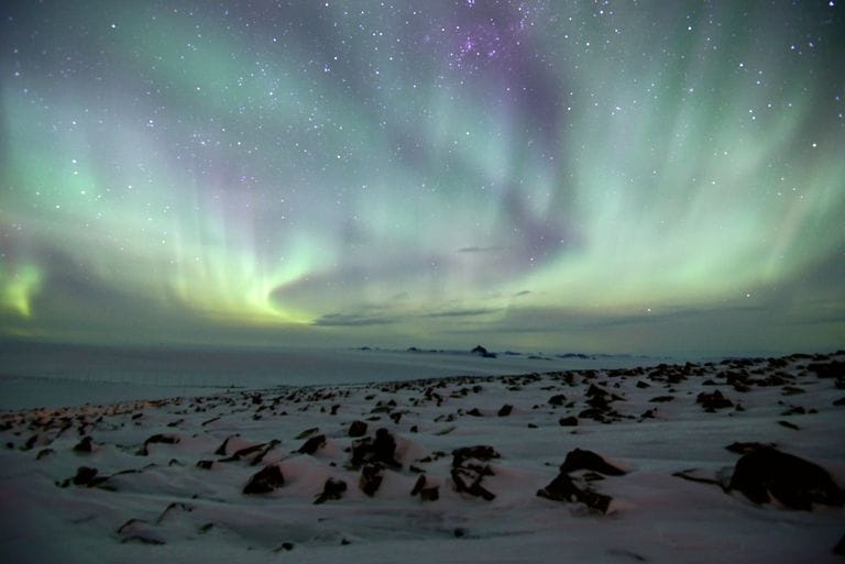 Nobel Prize Physics 2026: Francis Halzen Wins for IceCube Discovery 10 Stunning aurora australis illuminating the Antarctica night sky with vibrant colors and snow-covered landscape.